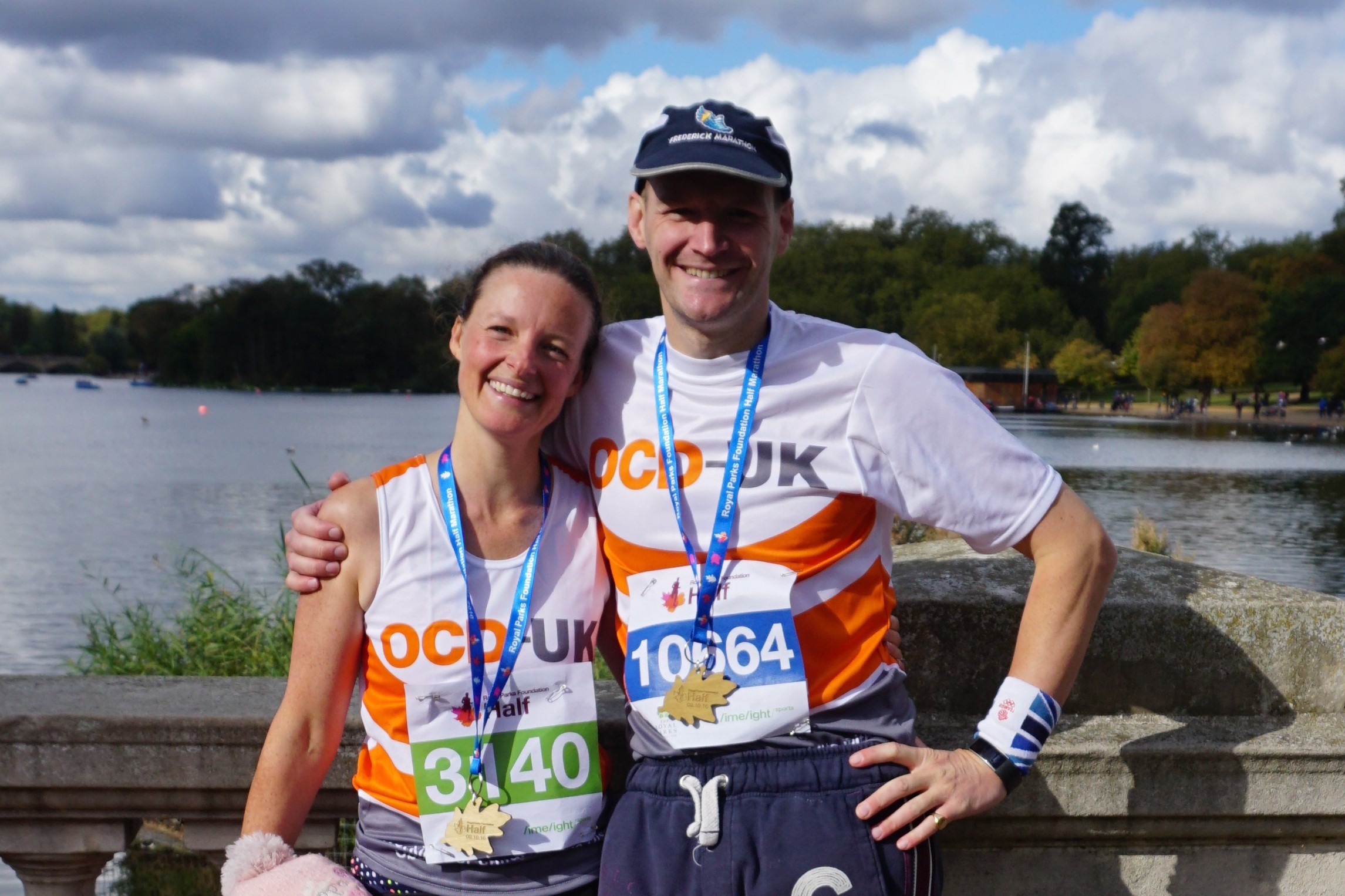 Kirstie crosses the finish line with her OCD-UK t-shirt and beaming smile with her arms in the air.